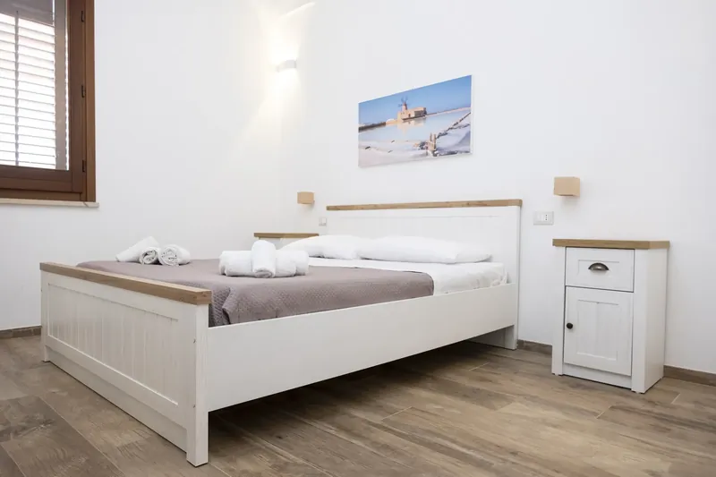 Bedroom with white furniture and a bedside table