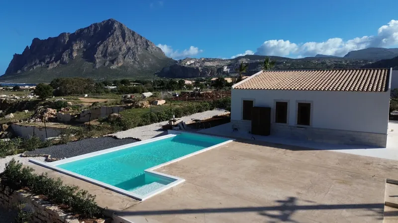 Monte Cofano rising behind the villa and its pool