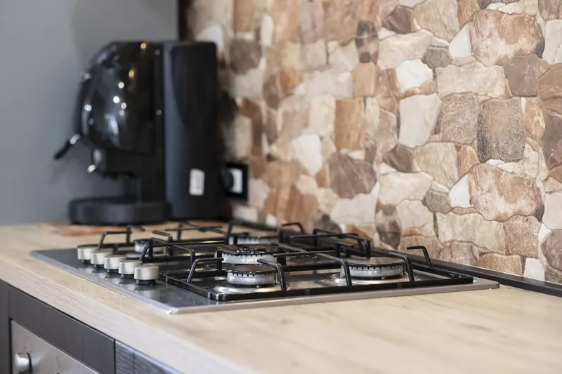Gas hob and exposed-stone detail