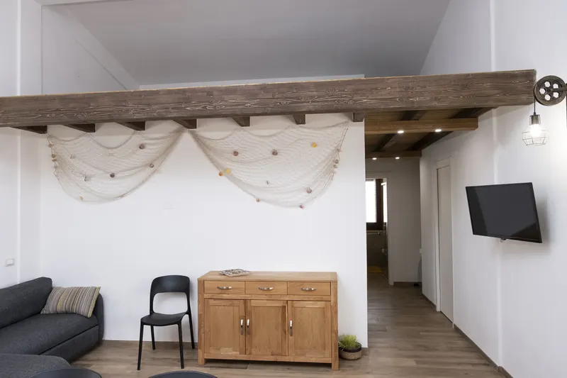 Living area with soft furnishings and stone walls