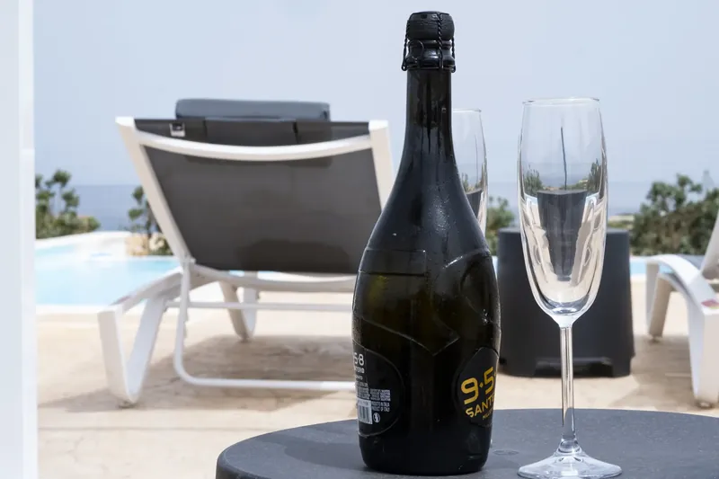 A bottle of prosecco chilling by the pool