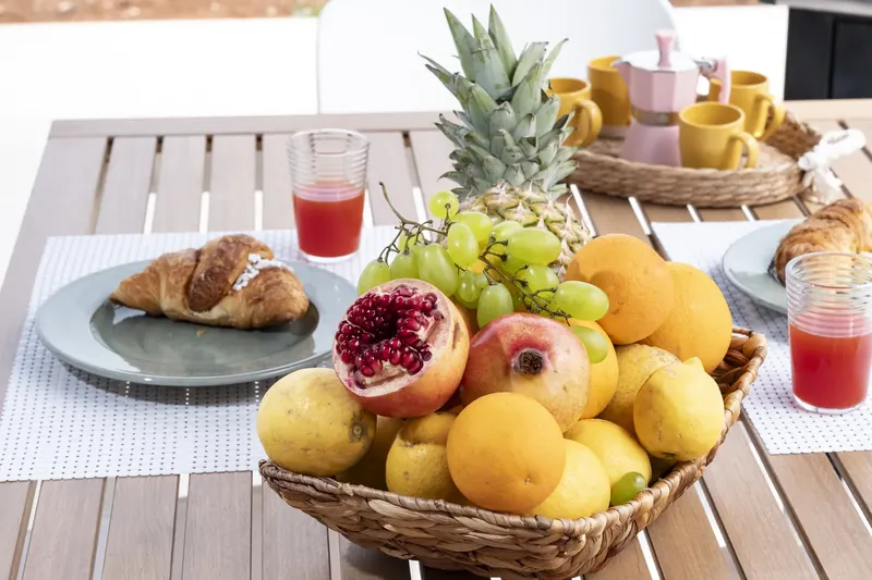 Breakfast and fresh juice with Monte Cofano behind